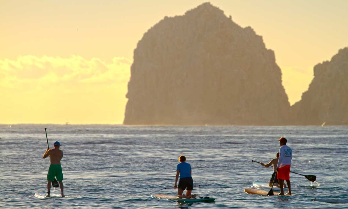 Parasailers enjoy an up close view of Land's End and the Arch in Cabo